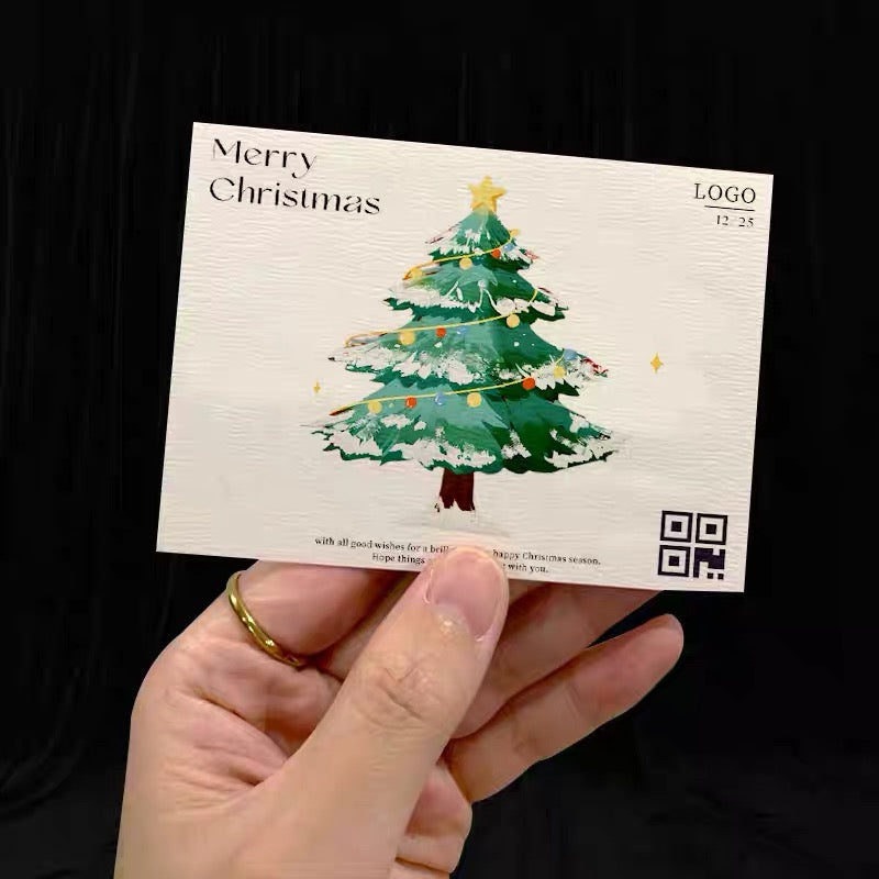Custom printed holiday card held in front of its packaging